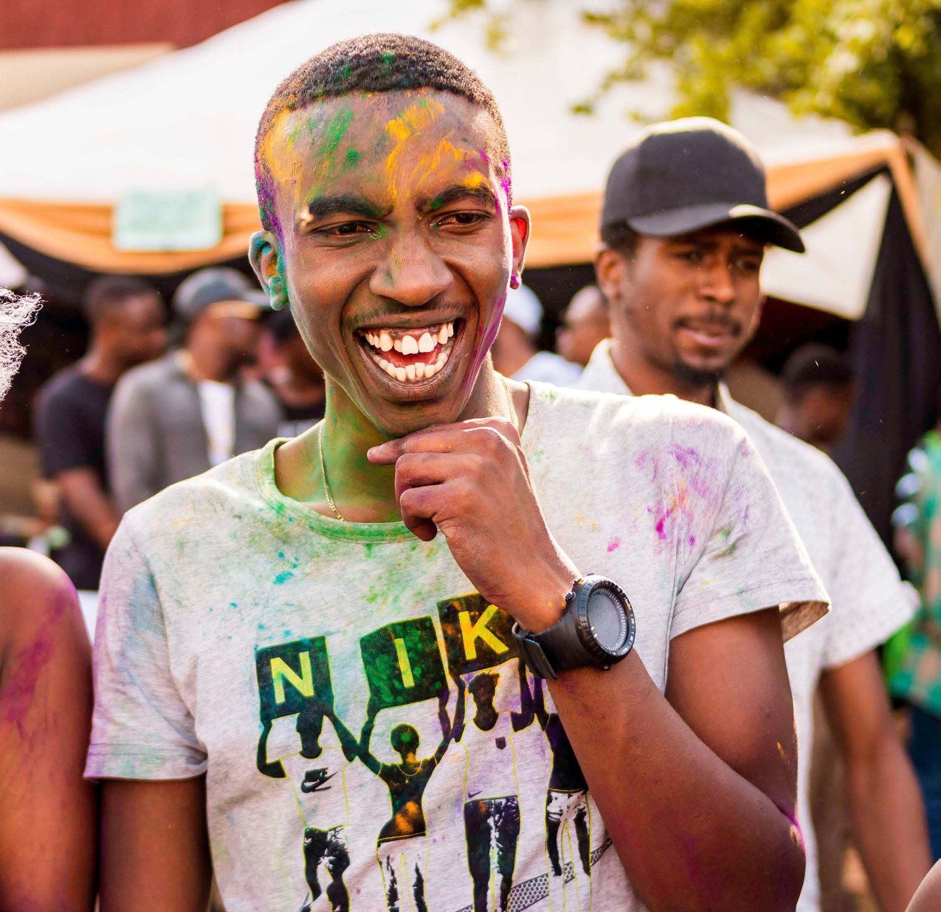 Smiling participant at a lively outdoor event