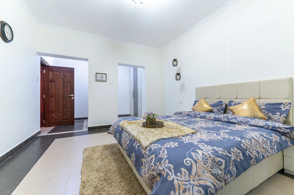 Bright bedroom with a patterned bedspread