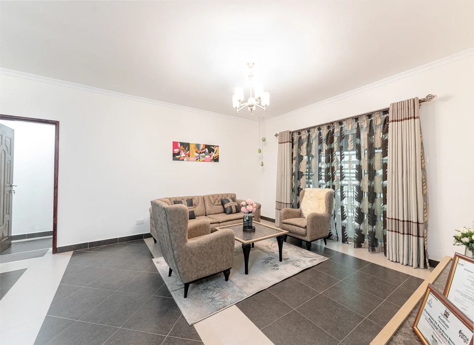 Bright living room with a sofa, coffee table, and dining area