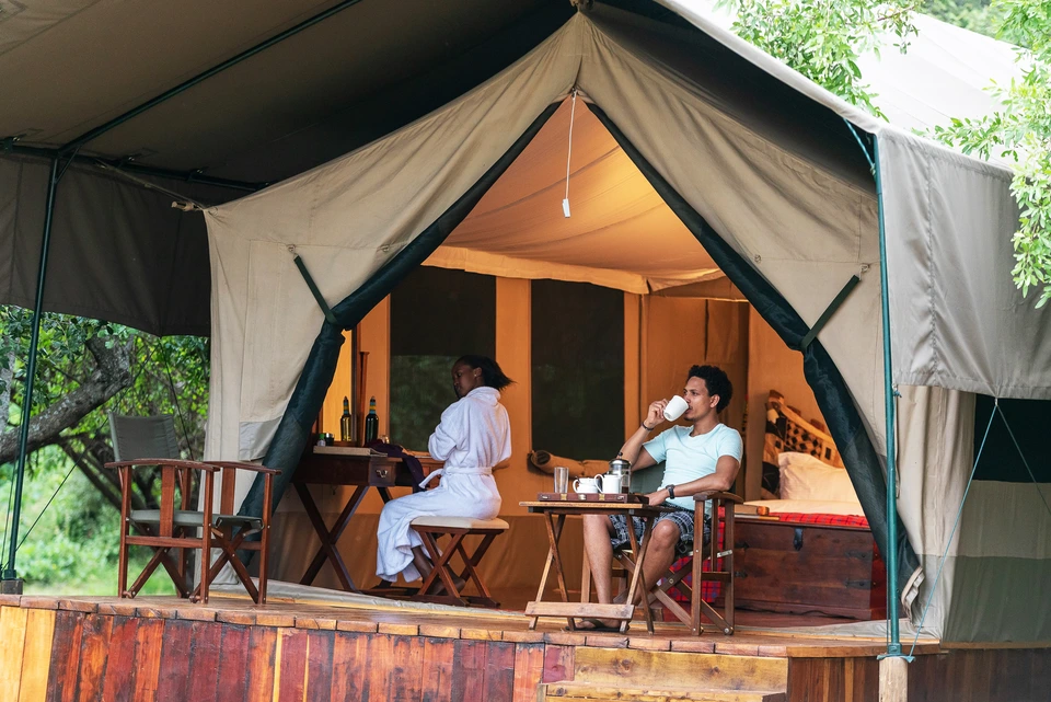 Canvas safari tent with an open veranda and seating