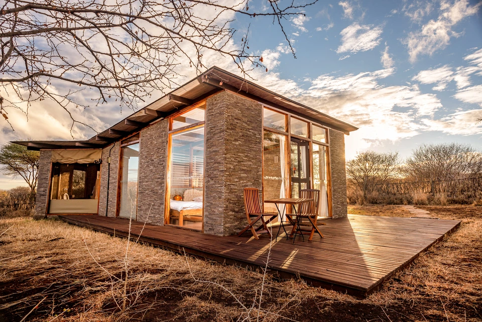 Small building with stone and timber finishes in a dry natural landscape