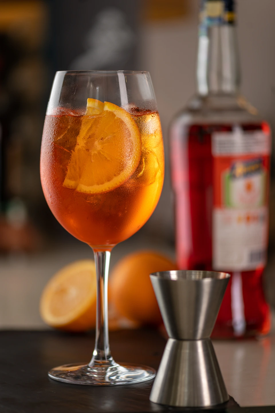 Orange cocktail in a stemmed glass on a bar counter