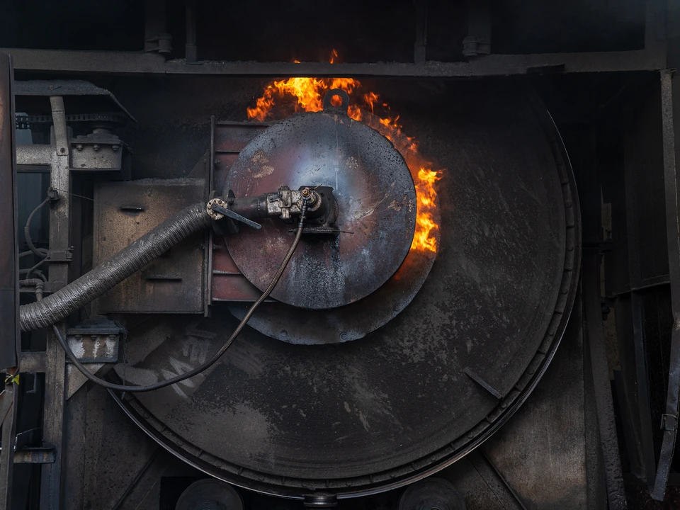 Industrial furnace with flames around its circular opening