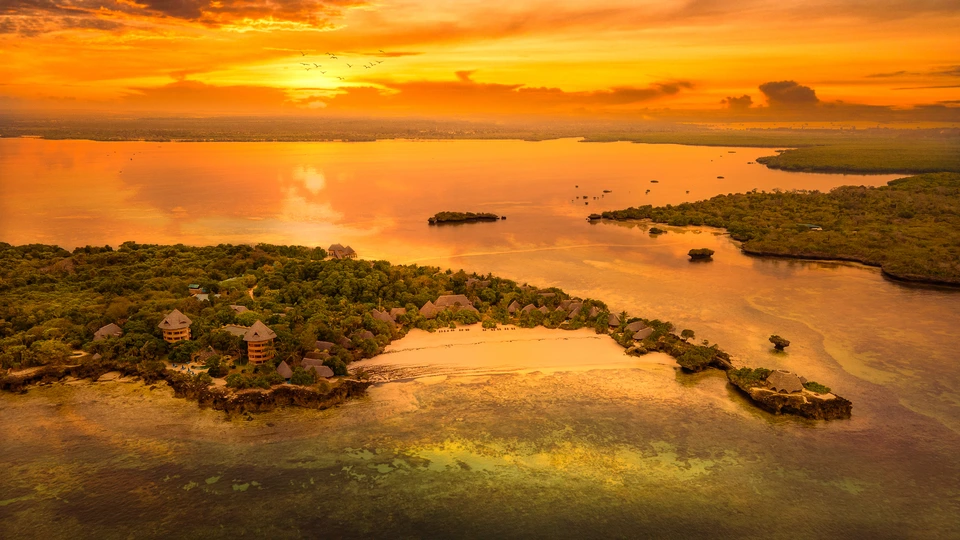 Golden sunset reflected in water and the surrounding landscape