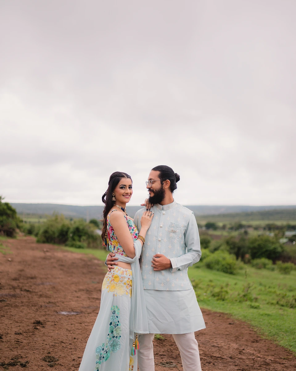 Wedding couple standing together in an open landscape