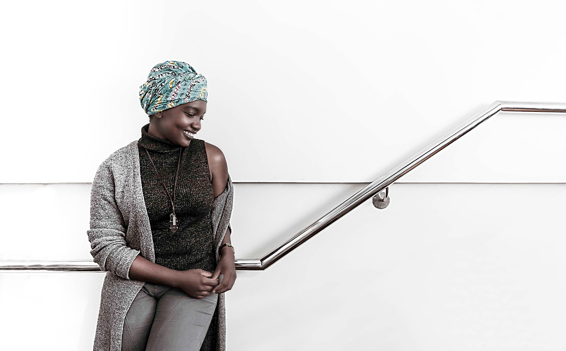 Black and white professional portrait beside a staircase